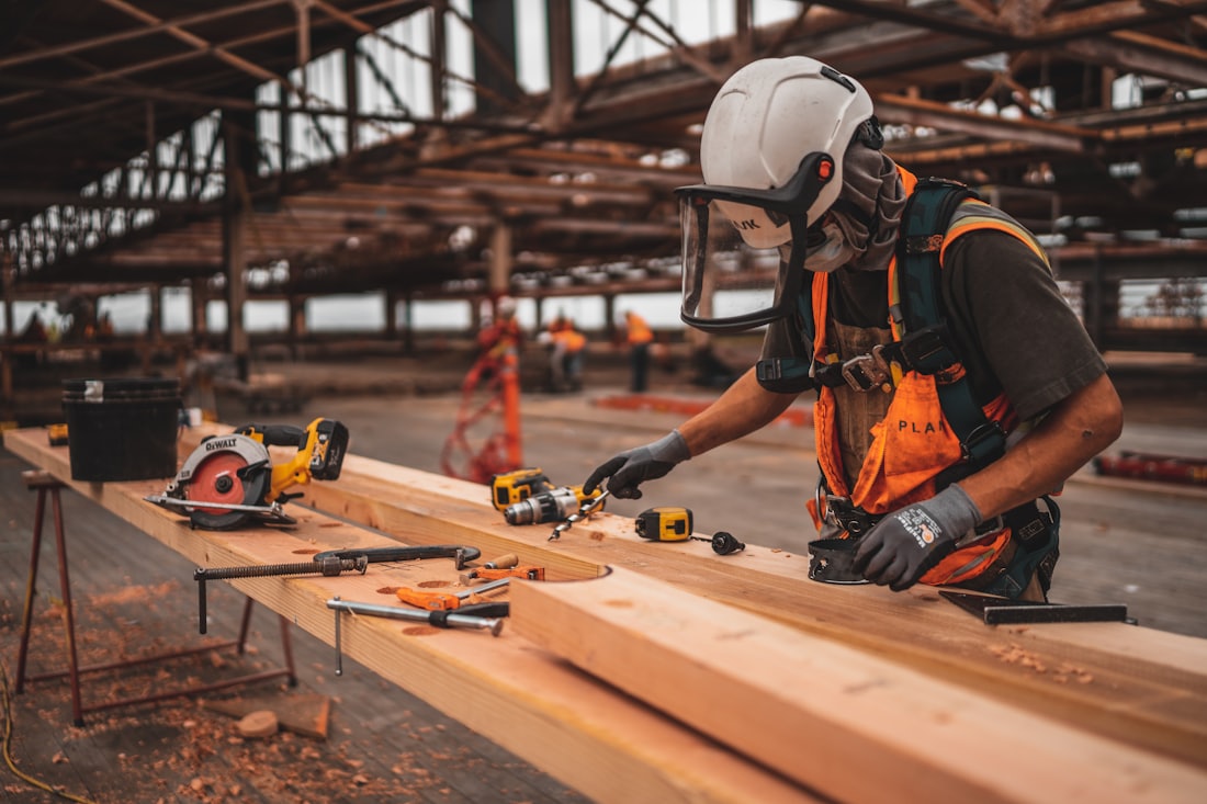 Tradesman measuring and marking timber on site
