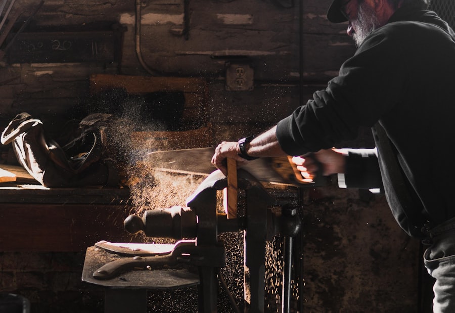 Carpenter hand sawing timber in a workshop