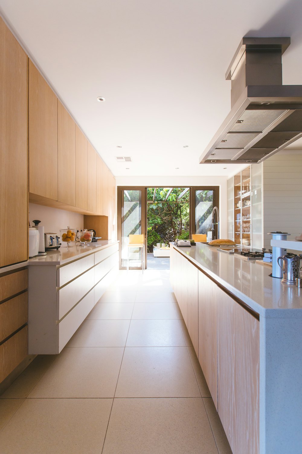 Fitted kitchen with tiled floor and timber units