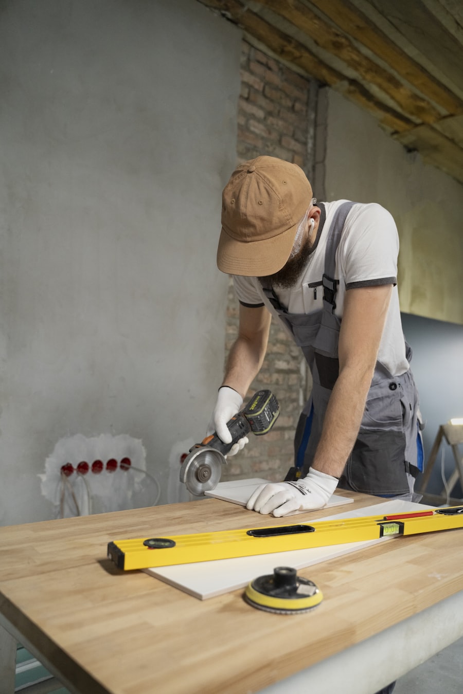 Tiler cutting a tile with an angle grinder